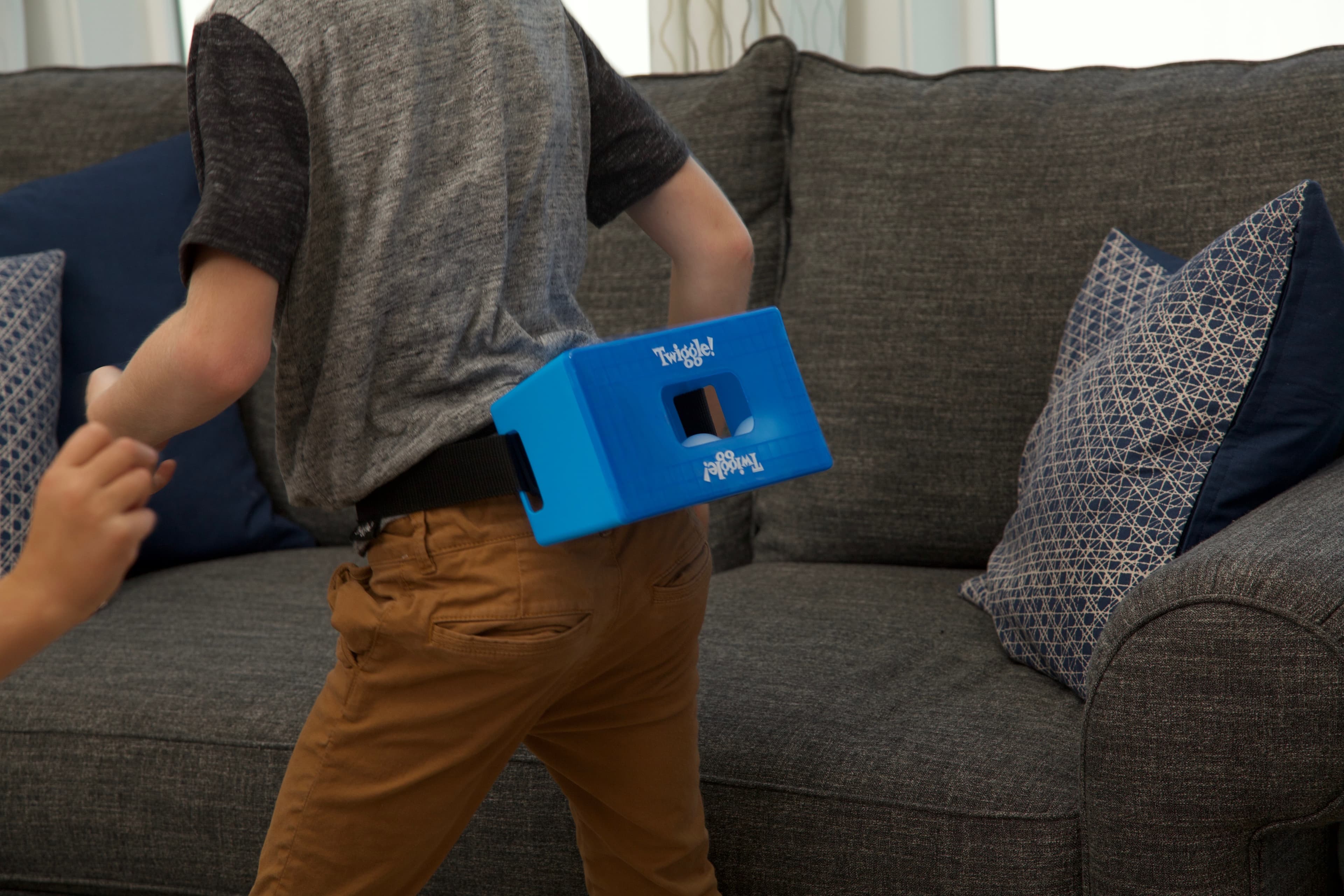 A kid mid-shake in a blue Twiggle box